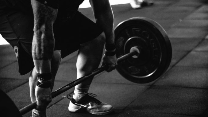 man successful bulking while lifting a weight